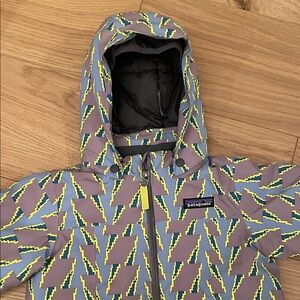 Patagonia Kids' Snow Pile one piece, in a pixelated lightning bolt pattern 2T